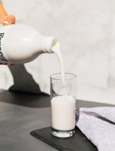 Cashew milk unsweetened pouring into glass