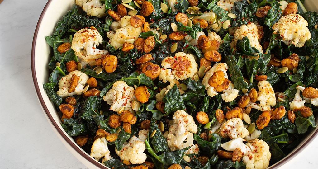 Overhead view of a large bowl filled with Lima Bean, Kale & Roasted Cauliflower Salad