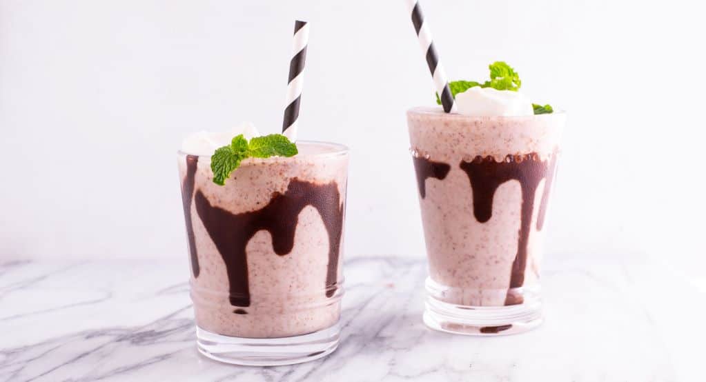 Two Glasses of Mint Chip Vegan Milkshake with Chocolate Drizzle