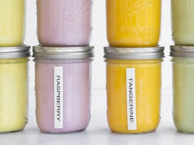 Mason jars filled with different flavors of smoothies.