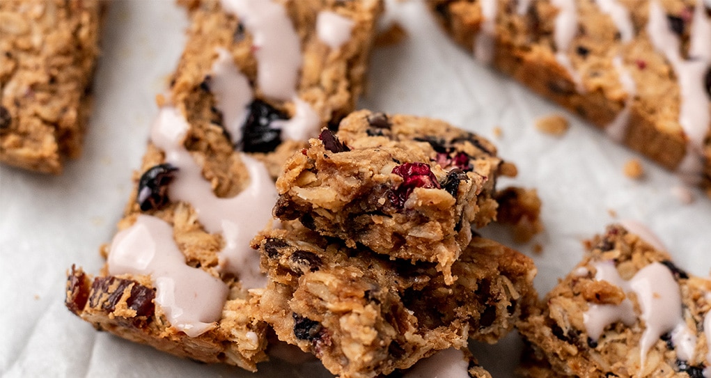 Close up of a homemade granola bar with yogurt drizzle.
