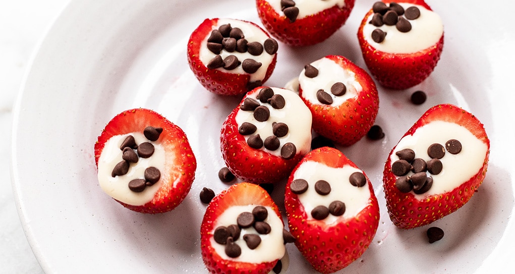 Strawberries filled with yogurt and mini vegan chocolate chips.