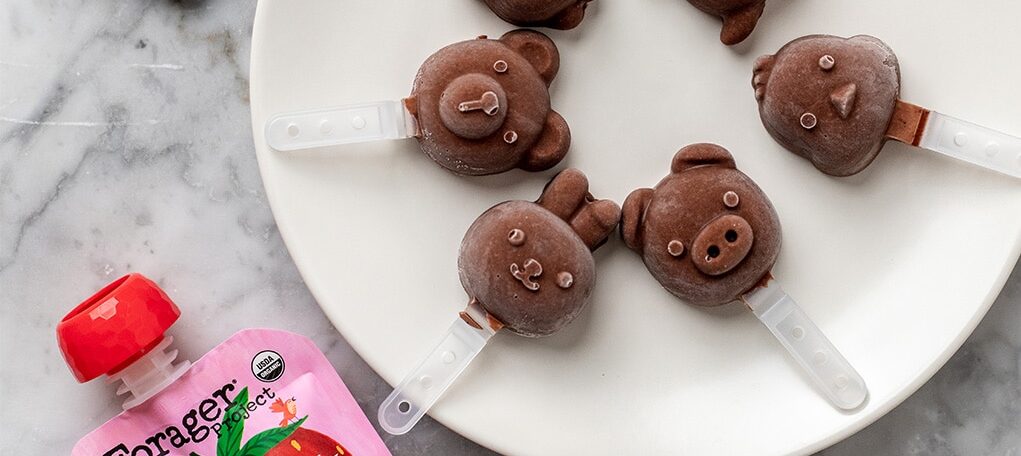 Plate topped with circle of mini chocolate popsicles in the shape of little bears.