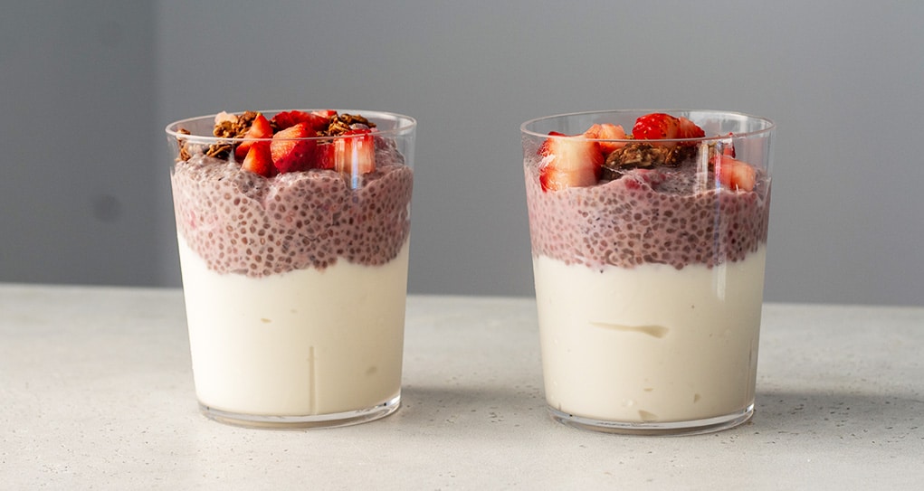 Two glass cups filler with berry chia pudding.